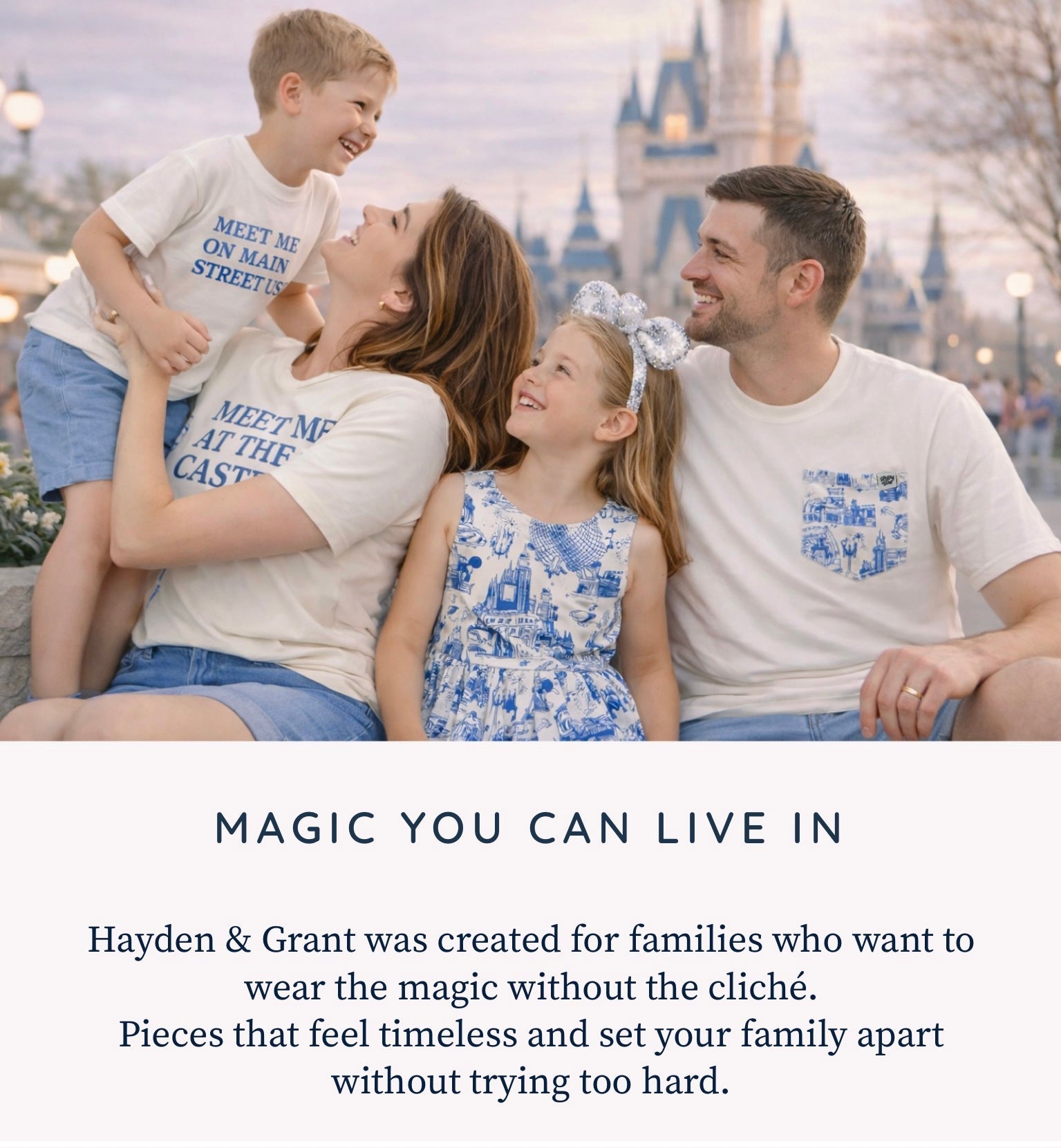 Family of four sitting together with a castle in the background, wearing matching shirts.